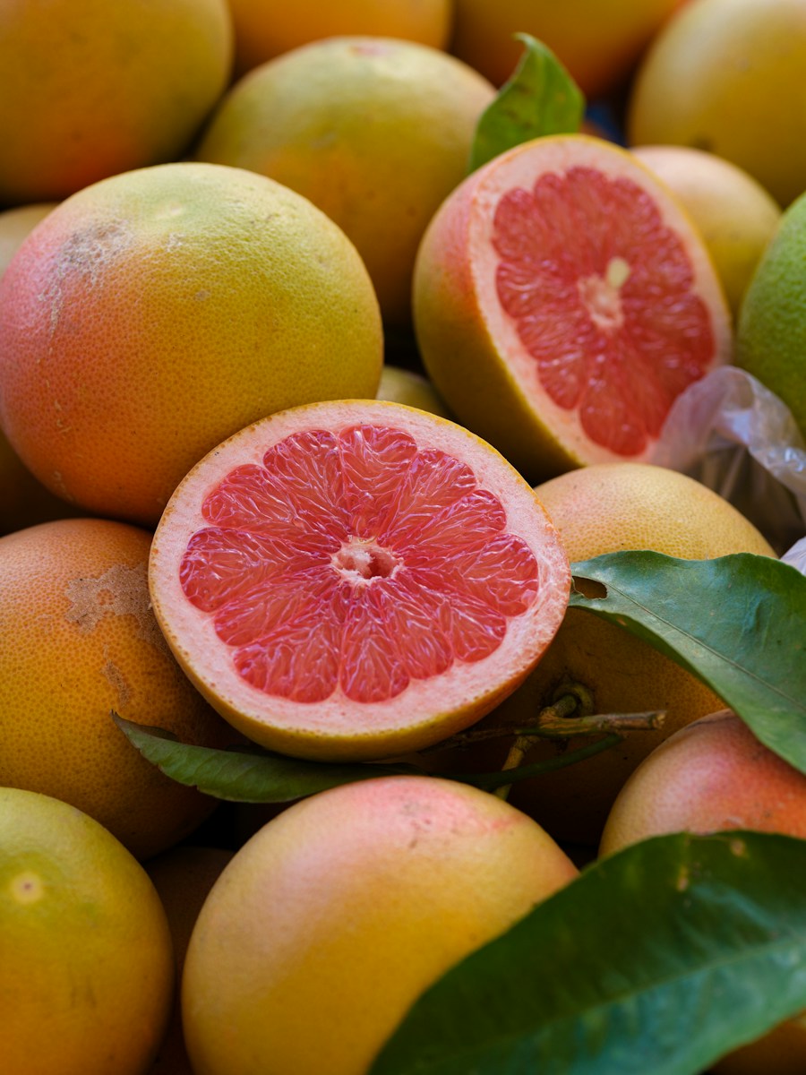 Grapefruits, one cut in half